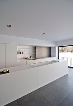 an empty kitchen with white cabinets and counter tops