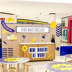 a store with several tables and chairs in front of the counter that says, kids's master class