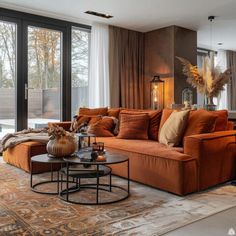 a living room filled with furniture and large windows