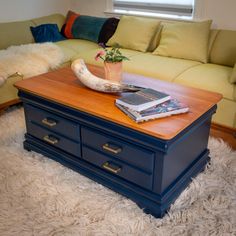 a blue coffee table sitting on top of a white rug