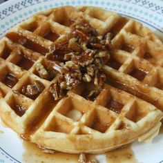 a plate topped with waffles covered in syrup