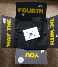 four pieces of black paper with yellow and white stickers on them sitting on the floor