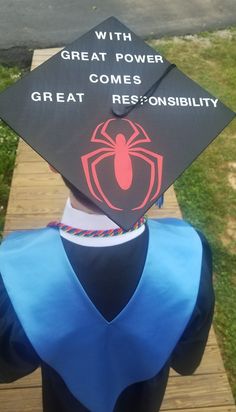 a person wearing a graduation cap with a spider on it