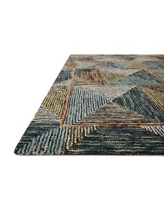 a multicolored area rug with an abstract design on the top and bottom corner