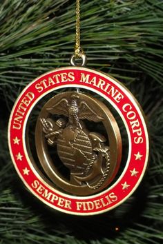 an ornament hanging from a christmas tree in the shape of a marine emblem