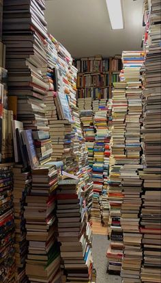 a room filled with lots of books on the floor