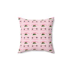 a pink pillow with tractors on it