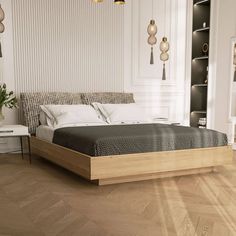 a large bed sitting on top of a hard wood floor next to a white wall