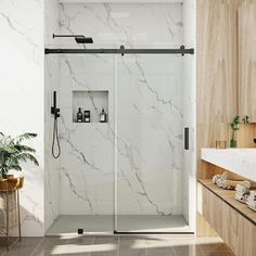 a bathroom with marbled walls and flooring is pictured in this image, the shower door is open