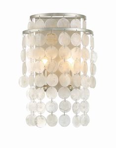 a chandelier that is hanging from the ceiling with lots of white discs on it