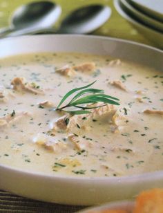 a white bowl filled with chicken and cheese soup