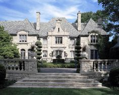 a large house with stone steps leading up to it