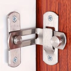 a close up of a door handle on a wooden door