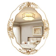 a mirror that is hanging on the wall above a bed with white sheets and pillows