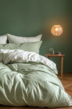 Inviting master bedrooms sage green with crisp white sheets and natural wood elements