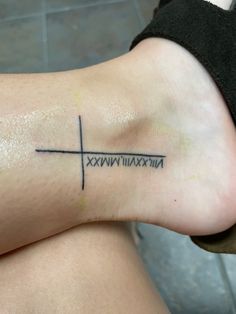 a person with a cross tattoo on their leg