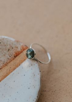 Our Dori ring is made with a gorgeous Labradorite stone. This mystical gemstone is believed to enhance mental clarity and bring about transformation. It's a crystal connected to the third eye chakra which is our gateway to inner wisdom and deeper intuition. 8mm round or 6x8mm oval labradorite stone. Ring band measures 1mm wide. Available in 14kt Gold Fill + Sterling Silver. Juliann stacks it with our Swell Ring and 2 Confetti Rings. KJ pairs it with our Sonder Ring, Raye Ring, and Confetti Ring. Confetti Ring, Copper Uses, Everyday Wear Jewelry, Backdrops Necklace, Zodiac Rings, Hoop Charms, The Third Eye, Inner Wisdom, Third Eye Chakra