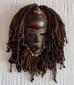 Vintage West African wooden mask from the Dan (Yakuba) Tribe, with the characteristic concave face, adorned with raffia headpiece decorated with cowrie beads and coarse braided locs. Wood sanded smooth and stained dark brown with die provides a lovely shiny patina highlighting the forehead and lips. Traditionally a sacred object, used for protection and communication with the spirit world. Good condition for age; light wear shows authenticity. Great entry level mask. *PLEASE NOTE THAT YOUR PHONE Braided Locs, Wooden Mask, Spirit World, Afro Punk, Art Object, Locs, Sculpture Art, Headpiece, Selling On Etsy