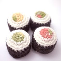 four crocheted cupcakes sitting on top of each other