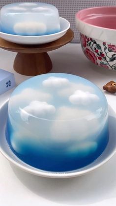 there are two plates on the table with clouds in them