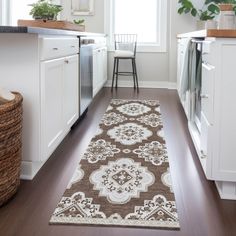 a brown and white runner rug in a kitchen