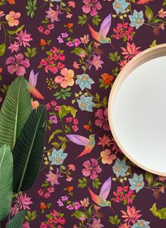 an empty plate sitting on top of a table next to a green leafy plant