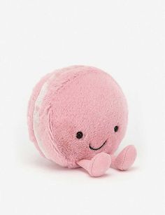 a pink stuffed animal with a smile on its face