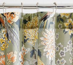 the curtains are hanging in front of the window with flowers on them and birds flying around