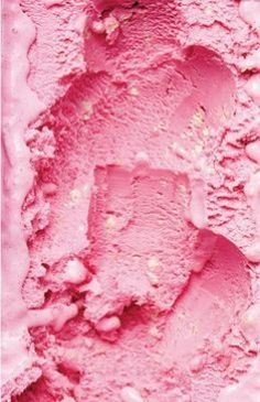 a pink ice cream textured with white dots on the top and bottom, as seen from above