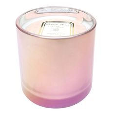 a pink candle is sitting on a white surface