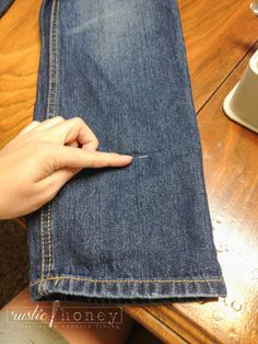 someone is sewing on the back of a pair of jeans