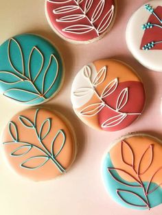 four decorated cookies sitting on top of a table