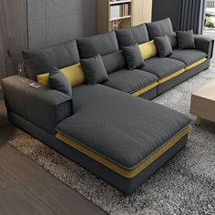 a large gray couch sitting on top of a carpeted floor