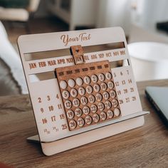 a wooden calendar sitting on top of a table