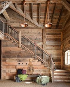 a room with wooden walls and stairs