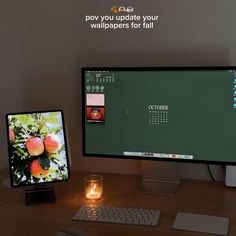 two computer monitors sitting on top of a desk next to a candle and glass vase