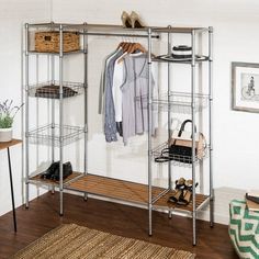 an organized closet with clothes, shoes and purses on shelving units in the corner