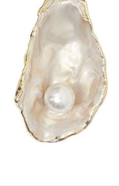 a pearl in an oyster shell on a white background