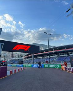 an empty race track in front of a stadium