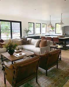 a living room filled with furniture and lots of windows