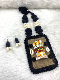 a necklace and earring set with an owl on it