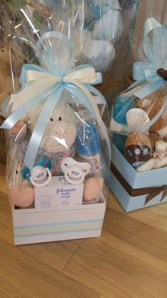 two baskets filled with stuffed animals sitting on top of a wooden floor next to each other