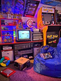 a room filled with lots of video game equipment and games on top of shelves next to each other