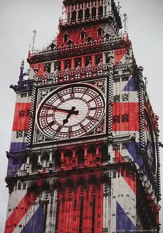 the big ben clock tower towering over london with red white and blue flags on it