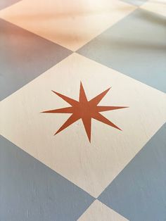 a red star on a checkered floor in the middle of an area that looks like it has been painted