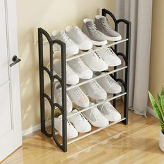 there is a rack that has many pairs of shoes on it in the corner next to a potted plant