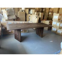 a wooden table sitting in front of boxes