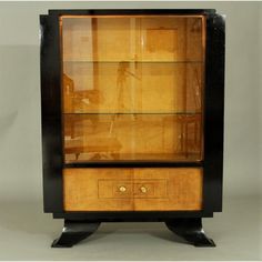 an antique display cabinet with glass doors and drawers on one side, in black lacquer