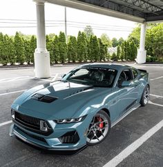 a blue sports car parked in a parking lot