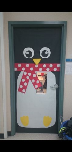 a penguin door decorated with polka dots and a scarf